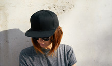 Portrait Of A Young Attractive Girl With Cap.Female Model Wearing A Black Blank Cap And Sunglasses Looking Away.