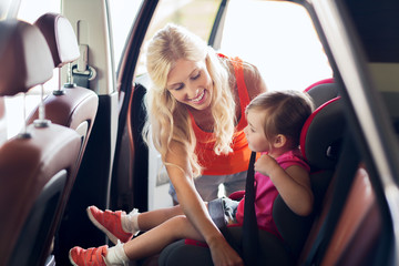 Canvas Print - happy mother fastening child with car seat belt