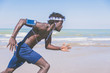 © Davide Angelini - Black athlete running man - Jogger training with smart phone armband.