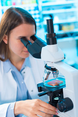 Wall Mural - Quality control of food products. Young woman in chemical labora