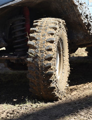 4x4 vehicle with tires full of mud to an off-road competition
