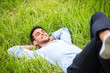 © Z A C - Beautiful young man lying, dreaming and relax on the green grass