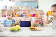 © Andrey Kuzmin - Funny kids eating fruits in day care centre