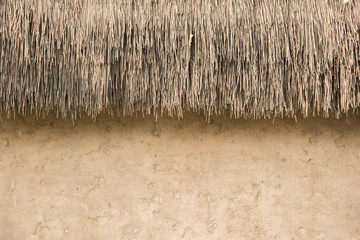 straw thatched roof  and  soil wall background