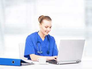 Wall Mural - Young, professional and cheerful female doctor working in office