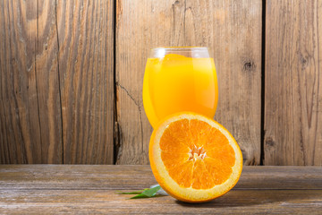 Wall Mural - Fresh orange juice with ice  on wooden background