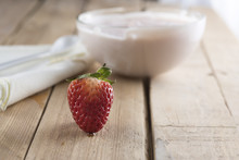 Closeup Of Delicious Strawberry Yogurt On Wooden Table. High Nutritional Value