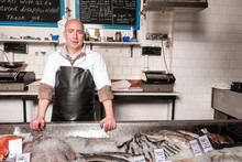 Fishmonger Behind His Fish Counter, UK