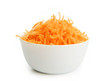 Grated carrots in a white cup on a white background