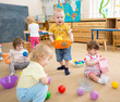 © Andrey Kuzmin - kids playing with balls in kindergarten room