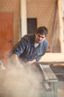 © natalialeb - man in  workshop, carpentry workshop tidying, dusting pneumatic