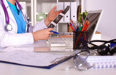 Wall Mural - Female doctor at the desk in the office