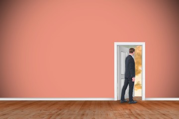 Canvas Print - Composite image of rear view of businessman in suit gesturing 