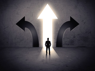 Businessman in front of three arrows