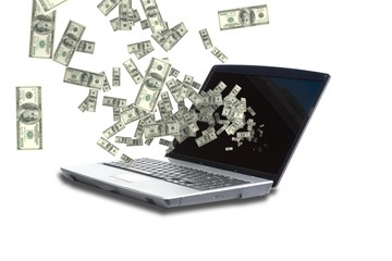 Digitally generated image of money from laptop screen