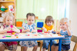 © Andrey Kuzmin - kids group learning arts and crafts in kindergarten with interest