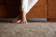 © mimagephotos - Woman feet on floor at home