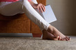 © mimagephotos - Woman feet on floor at home with digital tablet