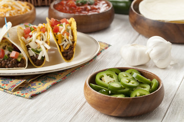 Sticker - a bowl of a slice green pepper with tacos on the background