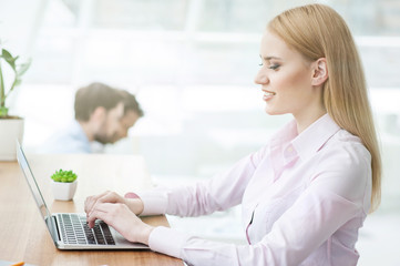 Sticker - Attractive female worker is using a notebook