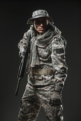 Special forces soldier man with Machine gun on a  dark background