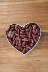 Wall Mural - red haricot on a heart shape container