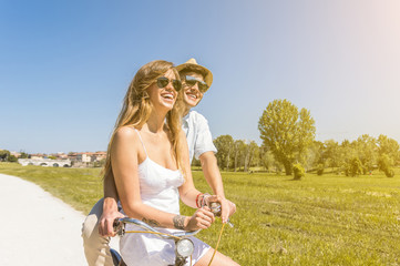 Happy couple riding bikes in the park