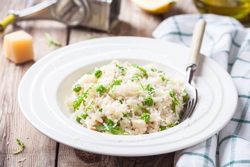 Wall Mural - Homemade risotto with chicken, green peas, arugula and parmesan