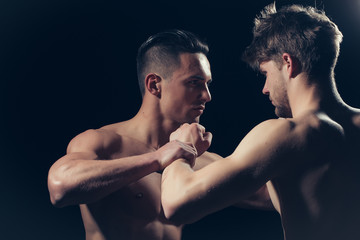 Young muscular men boxing