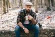 © anatoliycherkas - Bearded man drinking coffee in the forest