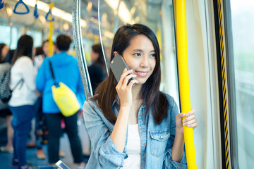 Sticker - Woman talk to cellphone inside train compartment