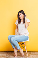 Sticker - Pretty young woman sitting on the chair