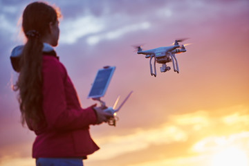 Wall Mural - drone quadcopter flying at sunset