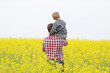© yra1111 - man with a child in a a blossom yellow field