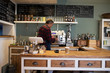 © chickenstockimages - Male Barista Preparing Hot Drink In Coffee Shop
