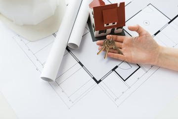 Poster - close up of hand with house keys and blueprint