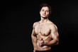 © Maksim Denisenko - Handsome athletic man showing thumb-up in black pants. Strong bodybuilder with six pack, perfect abs, shoulders, biceps, triceps and chest. Great fitness body. Ideal for commercial. black background