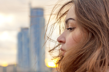 young attractive girl on the background of buildings