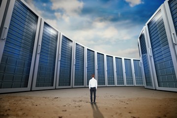 Wall Mural - Composite image of rear view of businessman with hands in pocket