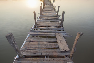 Wooded bridge in the port between on sunrise time