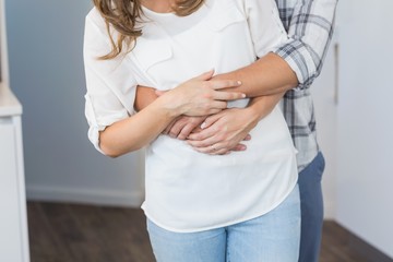 Wall Mural - Midsection of young couple embracing