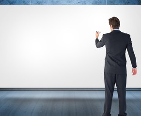 Wall Mural - Composite image of businessman standing back to camera writing w