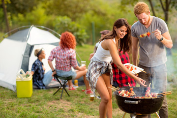 Wall Mural - Young brunette with boyfriend serving on plate barbecue