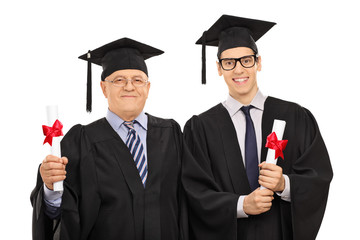 Canvas Print - Mature and young man posing with diplomas