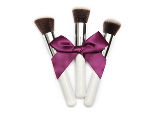 Big brush with purple bow isolated on white background