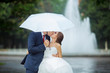 Happy Bride and groom at wedding walk white umbrella