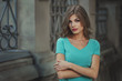 © oleg_p_100 - Outdoor lifestyle portrait of pretty young girl, wearing in blue dress on urban background. Creative color toned image.