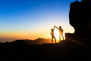 Wall Mural - teamwork couple climbing helping hand
