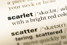 Close Up Of Old English Dictionary Page With Word Scarlet