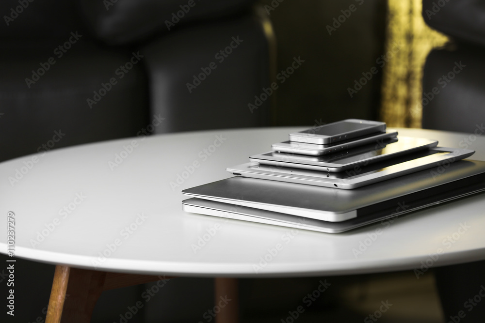 Pile of electronic gadgets on the table. Communication and technology concept